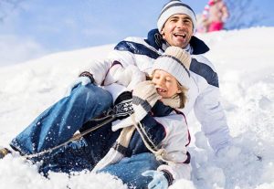 father and son on a sled